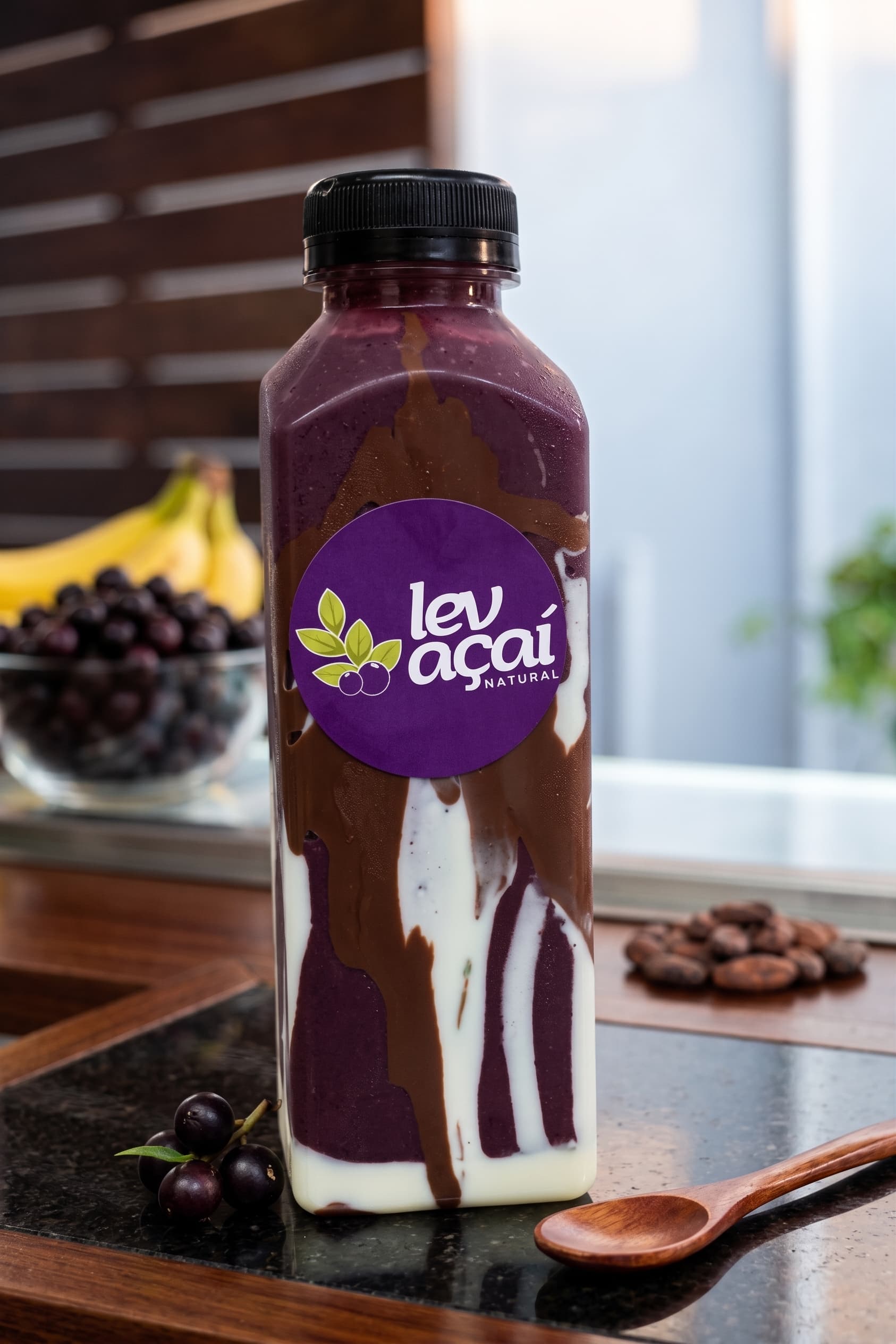 A bottle of LEV açaí with cream swirled inside the glass